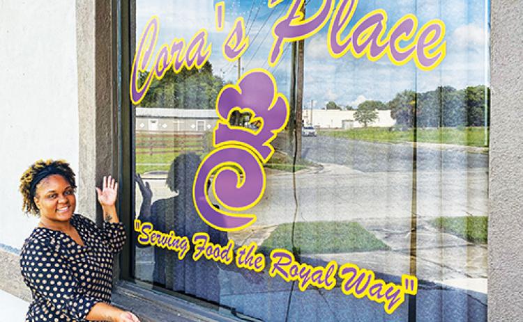 Restaurant owner and Putnam County native Cora Fells stands outside her Palatka eatery Thursday as she prepares for the grand opening, which will take place July 3.
