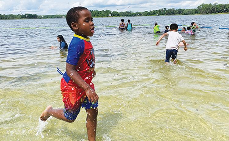 Children and their families get an early jumpstart on summer during the Putnam County Sheriff’s Office’s Cops, Kids and Kayaks event Saturday at Lake Stella in Crescent City. 