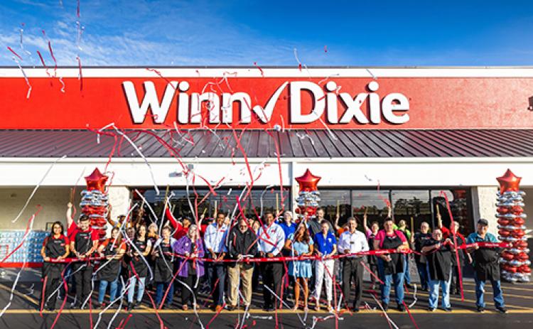Winn-Dixie employees celebrate the opening of the Melrose location with streamers, balloons and a grand-opening ribbon on Wednesday.