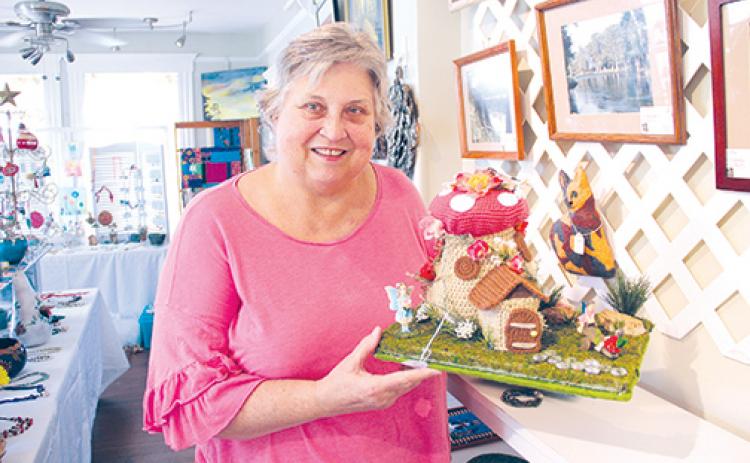 Palatka Art League member Debra Broome designed and crocheted the fairy house she is holding, which will be on display during the Palatka Art League’s Christmas in July event this weekend at the historic Tilghman House.