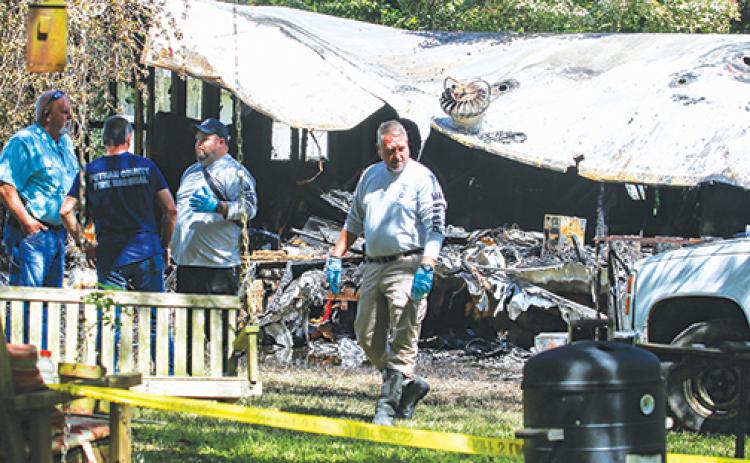 Putnam County and state officials investigate the cause of a mobile home fire in Satsuma on Friday morning.