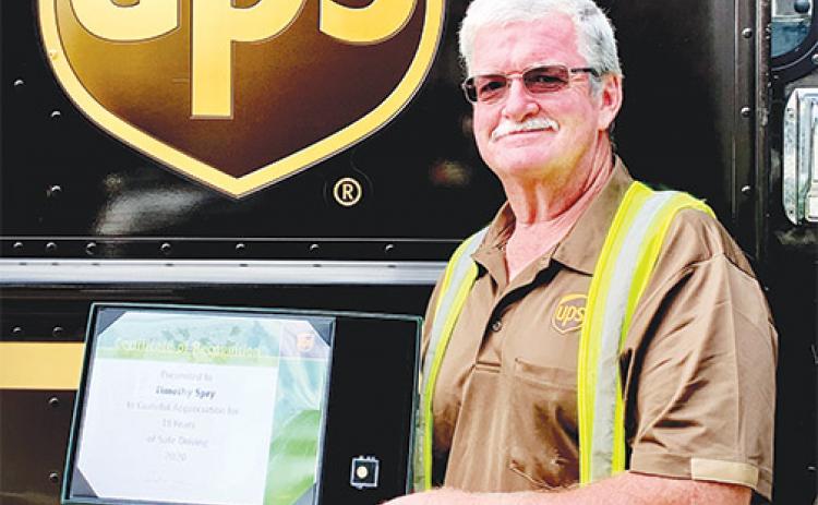 Tim Spry receives an award in 2020 for 18 years of safe driving as a UPS delivery worker.