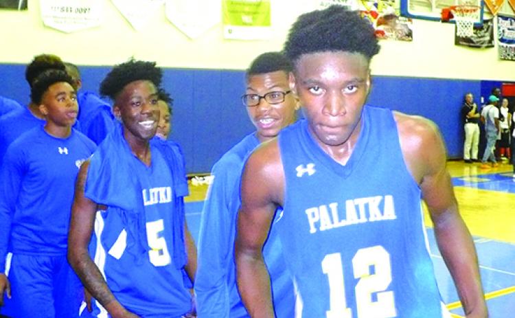 Wesley Roberts (12) and his Palatka High School boys basketball teammates are elated after beating New Port Richey Ridgewood for the regional title. (MARK BLUMENTHAL / Palatka Daily News)