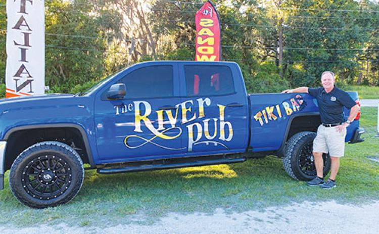Co-owner Bobby Glaize stands next to a River Pub-styled truck in front of his Georgetown restaurant, Bobby G’s River Pub.
