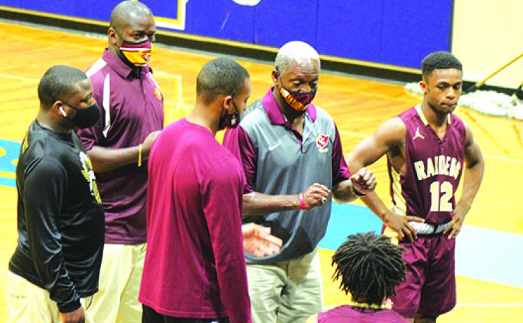 Al Carter (middle) emphasizes a point during a timeout during last December’s Jarvis Williams Holiday Classic at Palatka High School. (MARK BLUMENTHAL / Palatka Daily News)