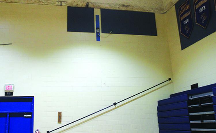 The back wall of the Palatka High gymnasium where the picture banners from the boys basketball team’s four state Final Fours hung is empty as of Tuesday. (MARK BLUMENTHAL / Palatka Daily News)
