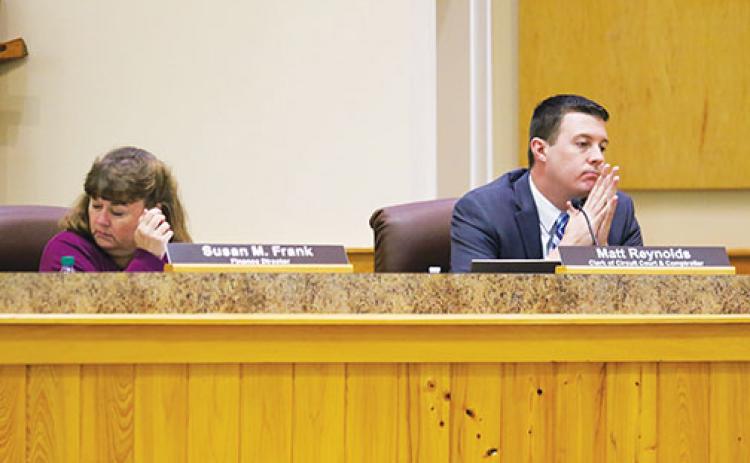 Finance Director Susan Frank and Clerk of Courts Matt Reynolds react to the Board of County Commissioners’ vote to have employees pay the difference in the shortage in the health insurance fund.