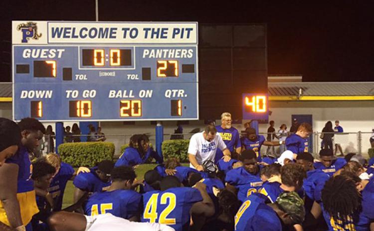 Palatka football coach Patrick Turner (middle) celebrates with his team after claiming its first victory of the season against Weeki Wachee, 27-7. (COREY DAVIS / Palatka Daily News)