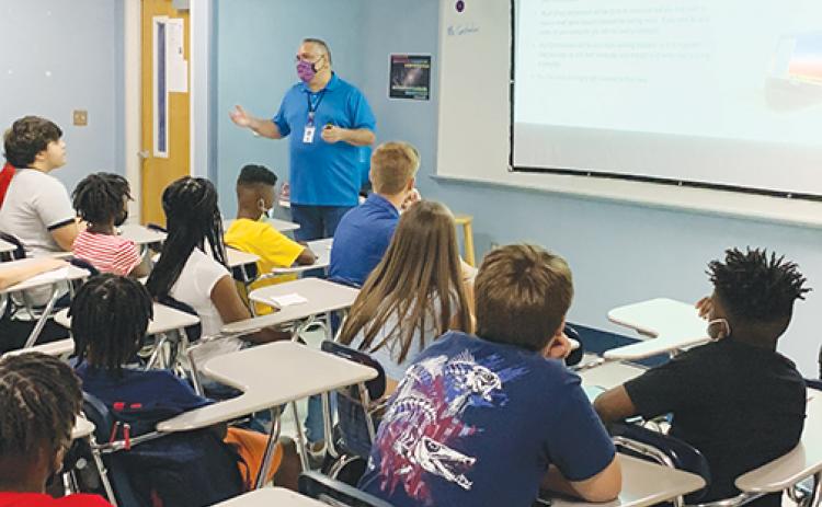 A teacher and students get down to business on the first day of classes at Palatka Junior-Senior High School.