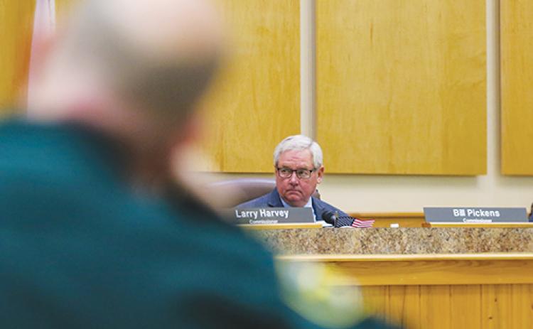 Commissioner Bill Pickens listens during a conversation about the county’s insurance fund deficit during a Board of County Commissioners meeting on Tuesday morning.