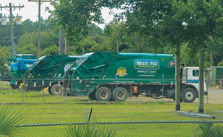 Waste Pro garbage collection trucks remain stationary Wednesday at the company’s facility in Palatka.