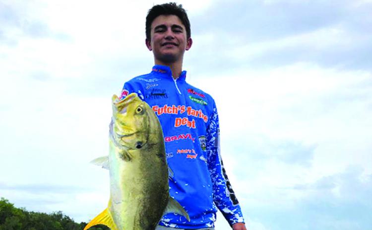 Jace Akers of Palatka shows off his Jack Cravelle before releasing  it back into the St. Johns River. They were fishing the B.A.S.S. Nation Jr./Sr. High School Bass Tournament Series earlier this month. (GREG WALKER / Daily News correspondent)