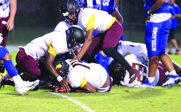 Protected by his teammates, Crescent City’s Josiah Washington (14) comes up with a fumble recovery at the 1-yard line during the first half of Friday’s game at Interlachen. (MARK BLUMENTHAL / Palatka Daily News)