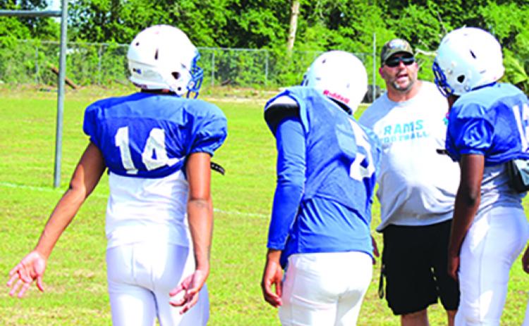 Interlachen Junior-Senior High football coach Erik Gibson chats with his players during a May practice. (MARK BLUMENTHAL / Palatka Daily News)