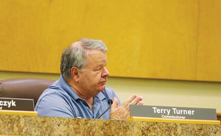 County Commissioner Terry Turner talks to county administrators Wednesday about lowering the countywide millage rate.