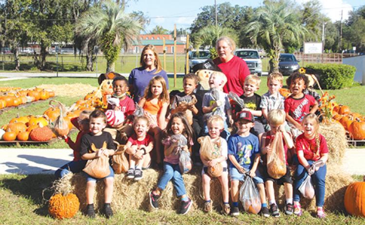 Pre-k students from Round Lake Academy are pictured with their teachers, Amy Hare, right, and Dixie Burkes, left, during a field trip Thursday to the Pumpkin Patch in Palatka.
