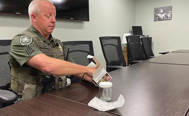 Putnam County Sheriff’s Office Sgt. Emmett Merritt pulls out the contents of a scent evidence kit that can be requested from the sheriff’s office.