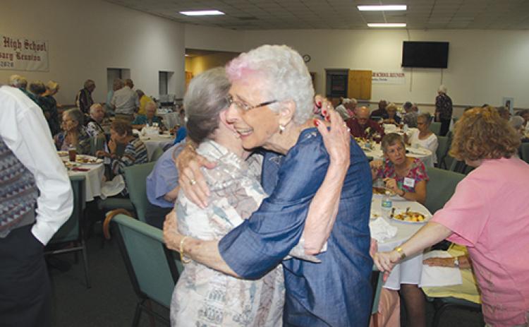Doreen Eubanks Partridge, left, and Alice Baggs Radcliff Farrell greet each other at the Putnam Mellon High School reunion Wednesday marking the 100th year since the school opened.