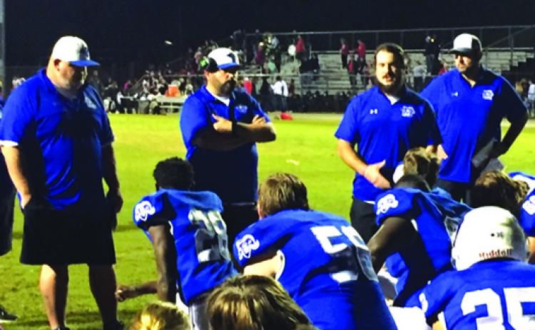Interlachen coaches talk to players after the team’s 14-7 loss to Fort White. (COREY DAVIS / Palatka Daily News)