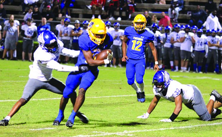Palatka running back Ty’ran Bush breaks the tackle attempt of Menendez’s Tomas Jones to eventually score on an 8-yard run in the second quarter of Friday night’s game. (MARK BLUMENTHAL / Palatka Daily News)