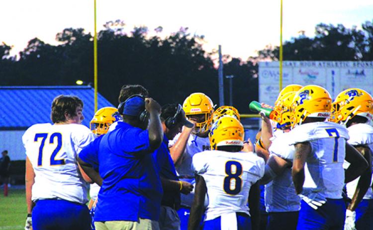 Palatka Junior-Senior High School coaches talk to players during a timeout during last Friday night’s loss to Clay. (COREY DAVIS / Palatka Daily News)