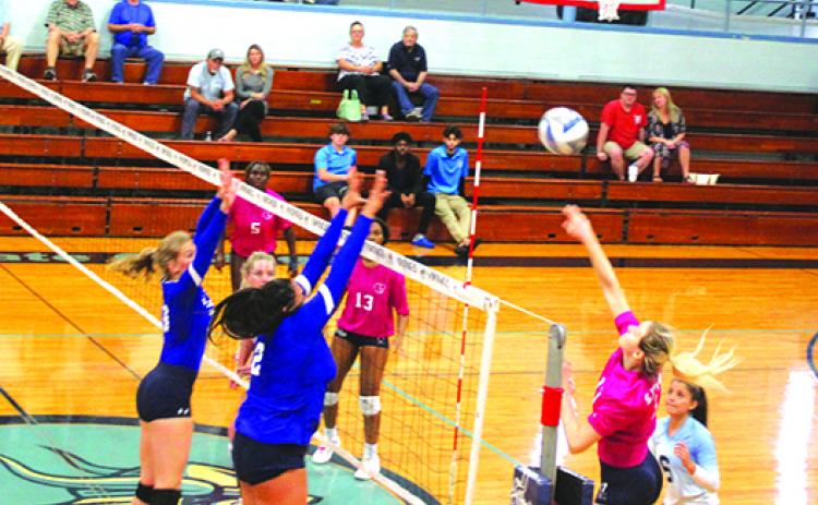 St. Johns River State College’s Mayya Kucherova (17) sends a spike over two Florida State College at Jacksonville players Oct. 19 in a Sun-Lakes Conference game, while teammate Dariana Luna (6) looks on. (MARK BLUMENTHAL / Palatka Daily News)