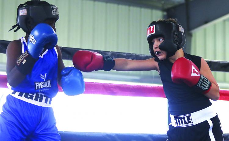Elijah Velez, right, trying to connect against an unidentified opponent on Nov. 5, won in the 10-year-old Pee Wee Division at 85 pounds as part of the Florida Amateur championships at the East Palatka Fairgrounds. (ALLISON WATERS-MERRITT / Special to the Daily News)