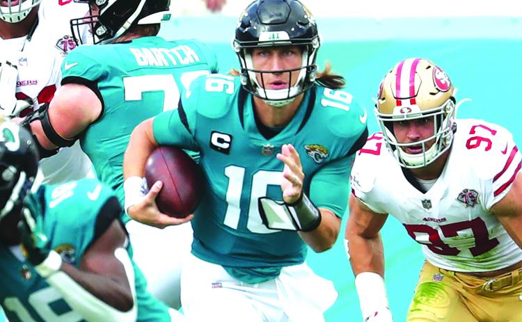 Jacksonville Jaguars quarterback Trevor Lawrence scrambles out of danger during Sunday’s 30-10 loss to the San Francisco 49ers. (JOHN STUDWELL / Special to the Daily News