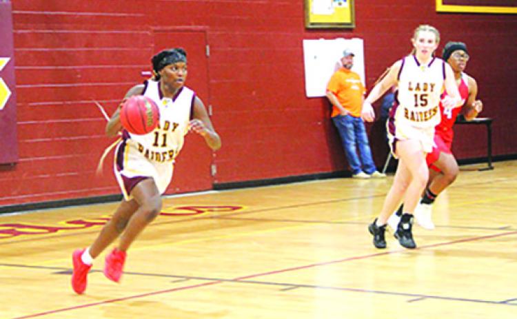 Crescent City’s Amarea Pates brings the ball up the court in the first half of Wednesday’s girls basketball game with Florida Deaf & Blind School. At the right is Crescent City’s Kendall Erkman. (COREY DAVIS / Special to the Daily News)