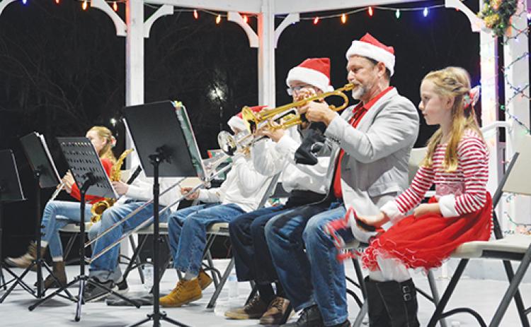 The Schwarb Family Band, part of The Purple Plum Players performance group, is seen performing holiday music for the crowds who came out to witness Crescent City’s Christmas Tree Lighting ceremony at Eva Lyon Park on Thursday evening