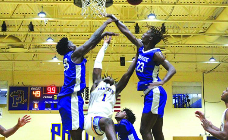 Palatka’s Jahmar Brown (1) is fouled while putting a shot up against Riverside’s Na’Jai Moody (35) and Dominick Scott during the third quarter of Friday’s boys basketball game. (MARK BLUMENTHAL / Palatka Daily News)