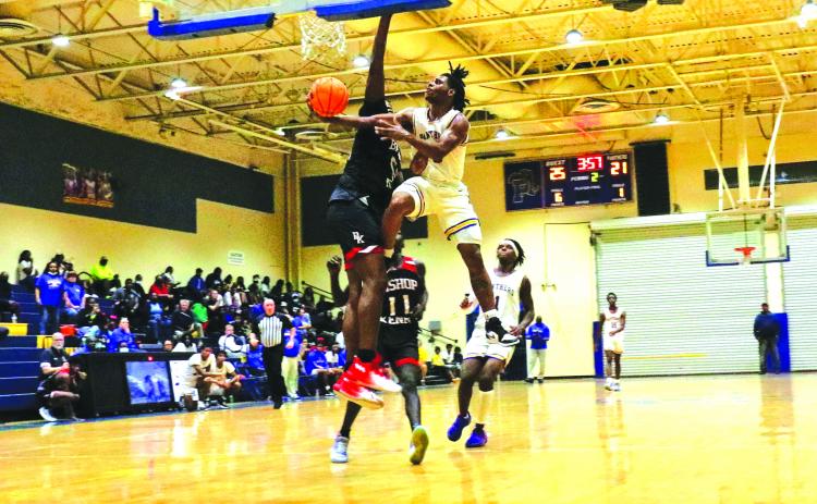 Palatka’s Jimmie Williams goes to the basket against Bishop Kenny’s O.J. Eziemefe during the second quarter of Tuesday’s game. (RITA FULLERTON / Special to the Daily News)