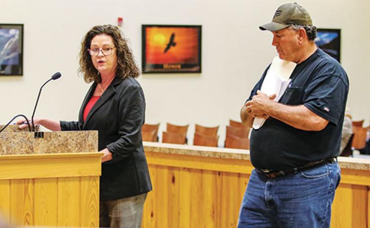 St. Augustine lawyer Kathryn Whittington and Hog Waller owner Skeet Alford speak before the Putnam County Board of Commissioners on Tuesday.