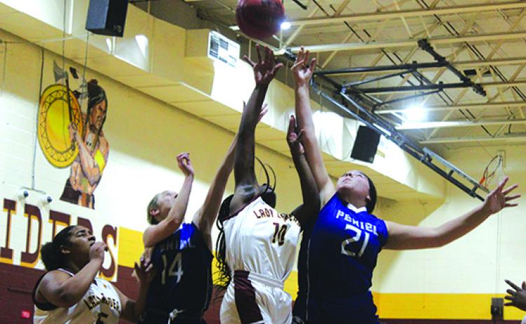 Crescent City’s Ty’reyaunna Jenkins (10) battles for a rebound against Peniel Baptist’s Joellie Tucker (14) and Abi Collier during Thursday night’s game won by the host Raiders. (MARK BLUMENTHAL / Palatka Daily News)