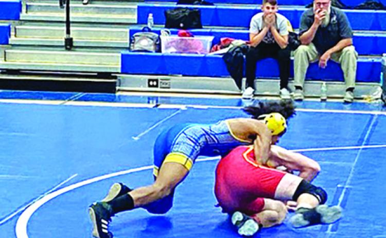 Palatka’s Ishmael Foster works his way to a pin against Baker County’s Gavin Sparkman in the 126-pound match Thursday at Clay High School. (COREY DAVIS / Palatka Daily News)