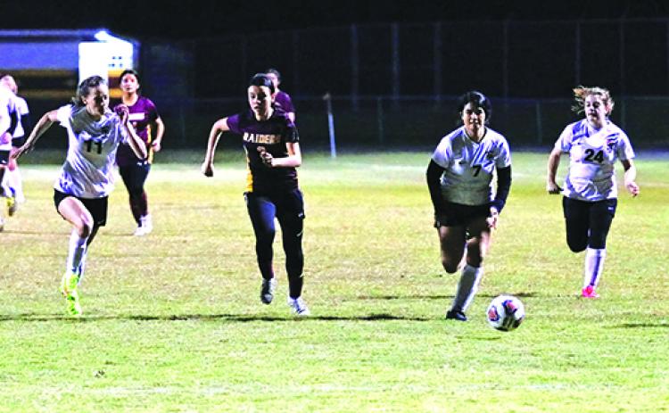 Crescent City’s Diana Quintana (second, left) chases after a loose ball against Umatilla’s Michaela Melchiorre (11), Iveth Cosio (7) and Halley Johnson during the first half of Wednesday’s District 5-3A tournament match. (RITA FULLERTON / Special to the Daily News)