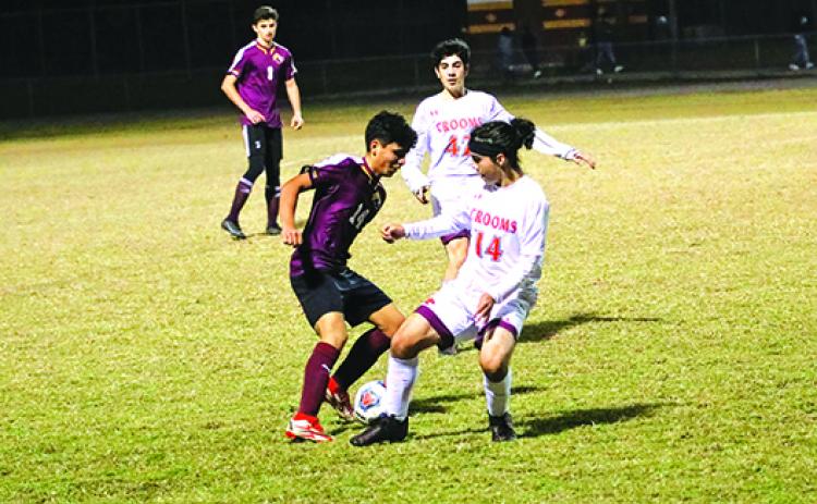 Crescent City’s Angel Consuelos (left) battles Crooms Academy’s Joaquin Casas Vivas for possession of the ball during Thursday night’s District 5-3A boys soccer tournament match. (RITA FULLERTON / Special to the Daily News)
