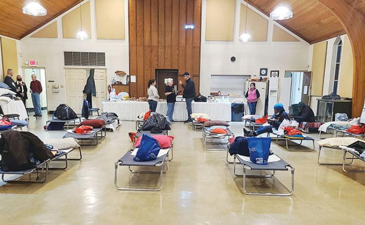 Cots are set up inside Westminster Hall at First Presbyterian Church in Palatka on Saturday for homeless people to take refuge from below-freezing temperatures.