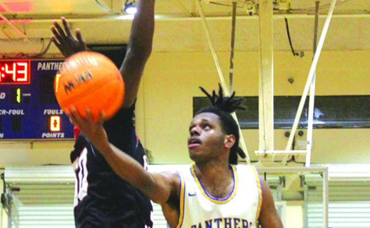 Palatka’s Jimmie Williams puts a shot up against Jacksonville Bishop Kenny during a game in December. The Panthers open play against the first-round winner of the North Marion-Keystone Heighrts game Wednesday night at North Marion High School in the District 4-4A tournament. (MARK BLUMENTHAL / Palatka Daily News)