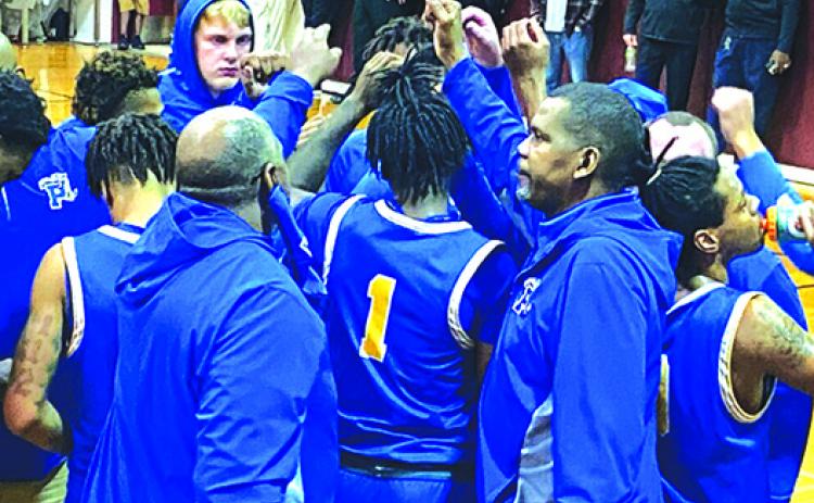 Palatka's boys basketball team huddles up before going on the court against North Marion Wednesday night. (COREY DAVIS / Palatka Daily News)