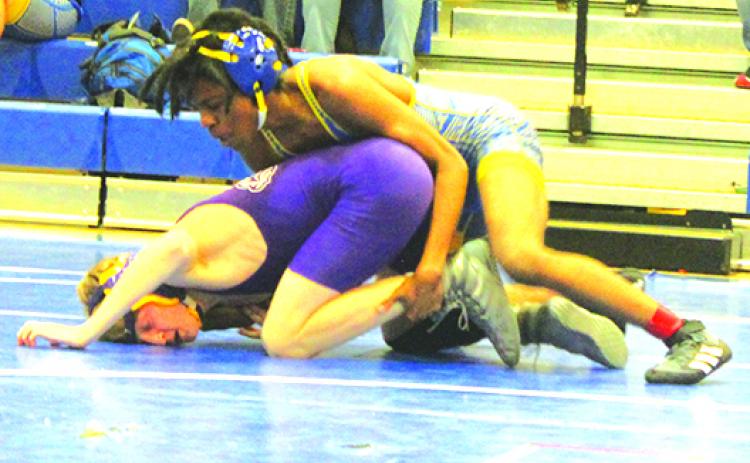 Palatka’s Demaris Carr, here winning his District 4-1A semifinal matchup last week against Union County’s Kale Waters, is one of seven wrestlers competing in the Region 1-1A championship. (MARK BLUMENTHAL / Palatka Daily News)