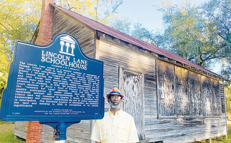 SARAH CAVACINI/Palatka Daily News Leo Granger, a member of the Interlachen Historical Society, stands in front of the Lincoln Lane Schoolhouse on Tuesday.