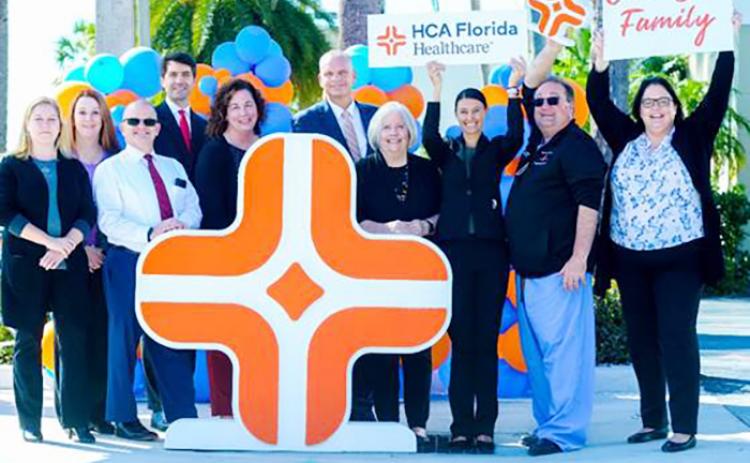 Physicians and colleagues at HCA Florida Fawcett Hospital in Port Charlotte celebrate their parent company’s rebrand with a larger-than-life Diamond Plus mark.