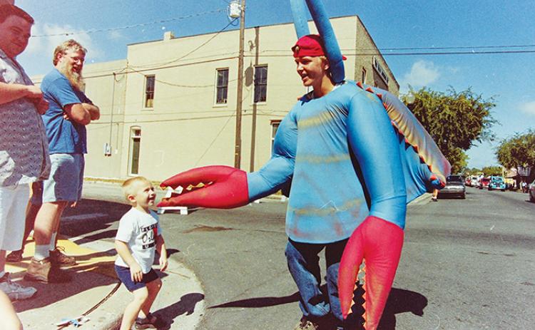 A man dressed as a blue crab greets people along St. Johns Avenue during the Blue Crab Festival in 2001.