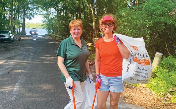 Corky Daniel, left, and Gina Gillman do their part in a previous Woman’s Club event as part of the Great American Cleanup. This  year’s events will take place throughout the month.