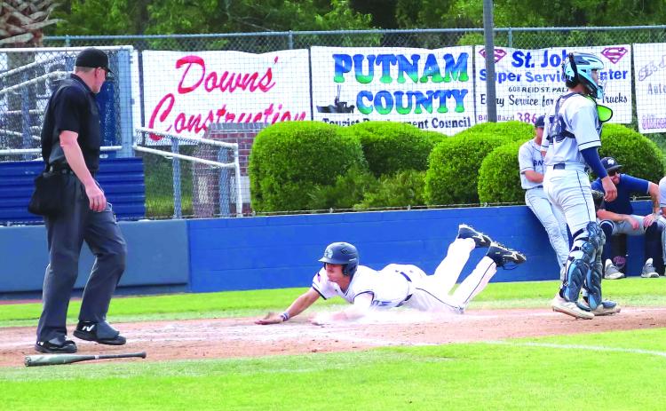 St. Johns River State College’s Elijah Guilliams slides home safely with a second-inning run, while Santa Fe catcher Santiago Garavito awaits the throw. (RITA FULLERTON / Special to the Daily News)
