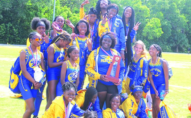 State champion thrower Torryence Poole holds the trophy as the Palatka Junior-Senior High School girls track team has fun celebrating its district championship for the first time this century. (MARK BLUMENTHAL / Palatka Daily News) 