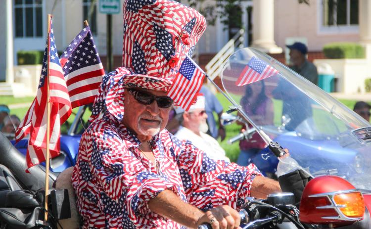 A man shows his Memorial Day spirit in a head-to-toe American flag ensemble as he rides in Palatka's Memorial Day parade on Monday 
