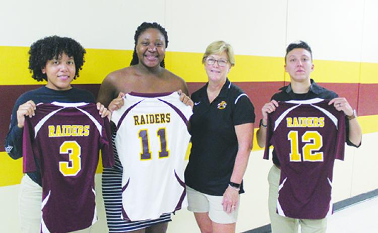Former longtime Crescent City coach Holly Pickens (third from right) poses with All-County standouts (from left) Vicktoria Williams, Kayshia Brady and Alexis Sepulveda last September after their 2011 FHSAA 1A Final Four team was honored before a game. (MARK BLUMENTHAL / Palatka Daily News)