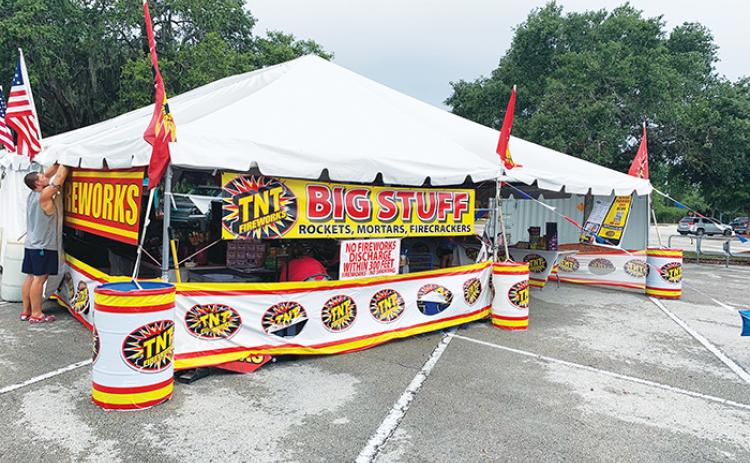 A fireworks vendor puts the finishing touches on his tent ahead of his group selling pyrotechnics in the Walmart parking lot in Palatka last year.